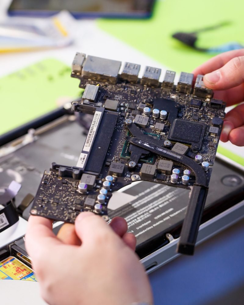 Professional computer and tablet repair shop or service. Close up of a computer board. Electronics concept. Detail from a laptop under repair